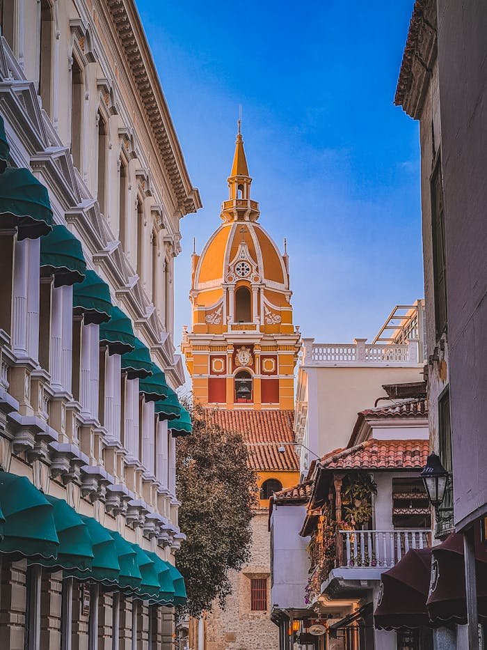 pexels-photo-13837939 Charming view of Cartagena's colonial architecture with vibrant colors and detailed design in a narrow alleyway.